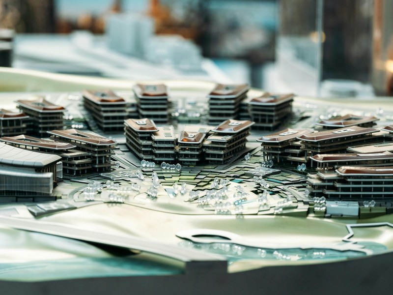 Architectural model and blueprints on the planning table
